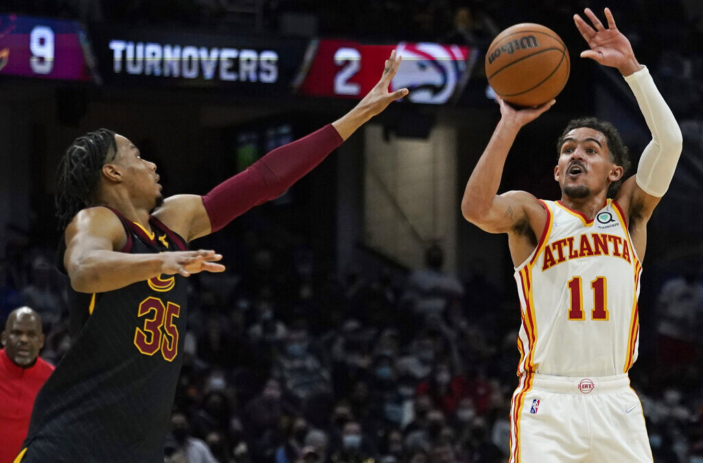 Atlanta Hawks player taking a free throw while Orlando Magic players prepare to rebound during an NBA game.