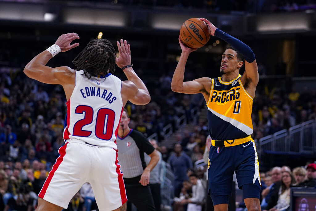 Indiana Pacers player shooting over a defender.